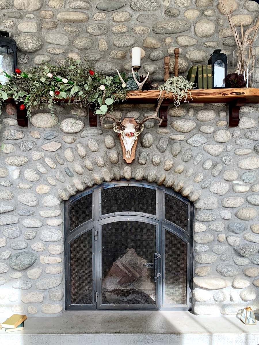 How To Update a 1970’s Stone Fireplace: 7+ DIY Ideas brown wooden cross on brown brick wall