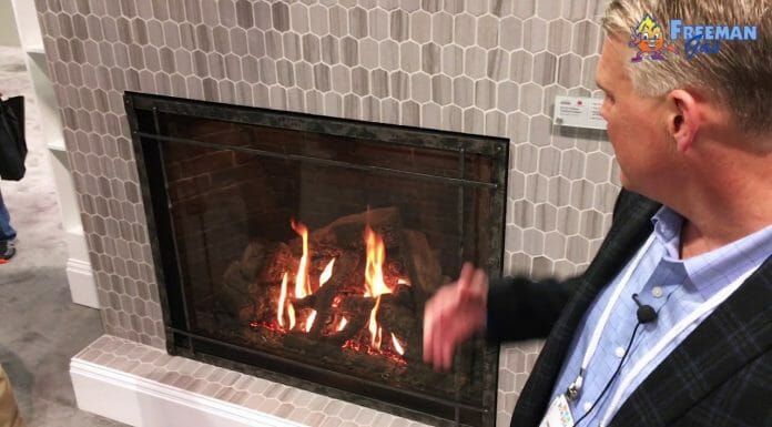 Empire Fireplaces: Everything You Need To Know A man is talking to a man in front of a fireplace.